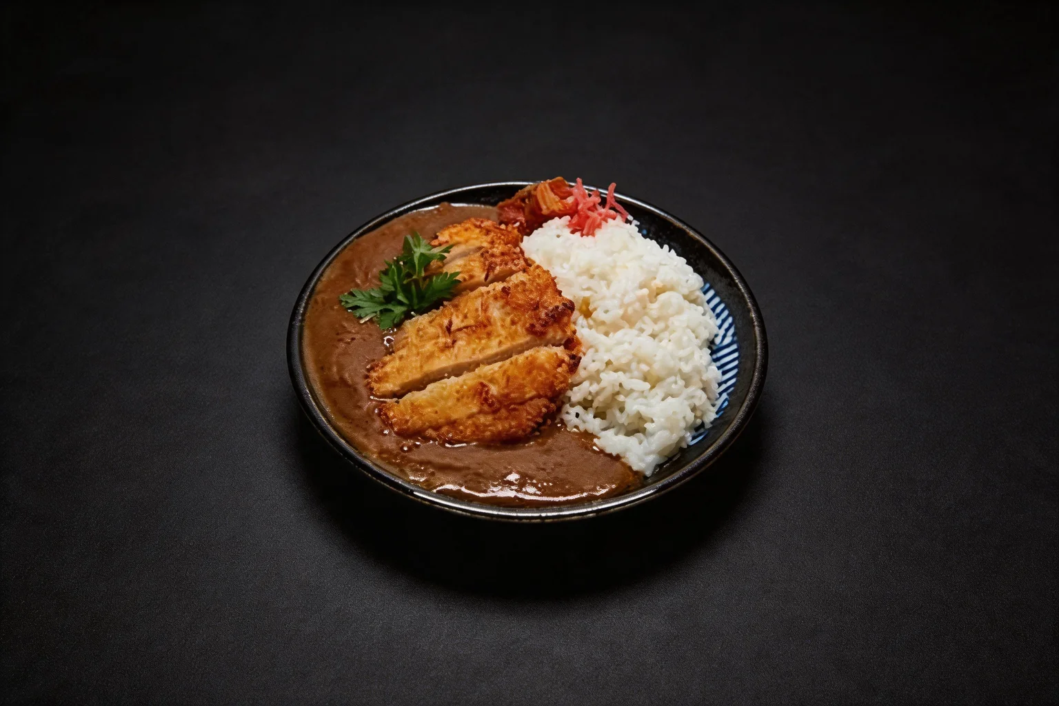 Katsu curry in a deep black and blue plate, dark background.